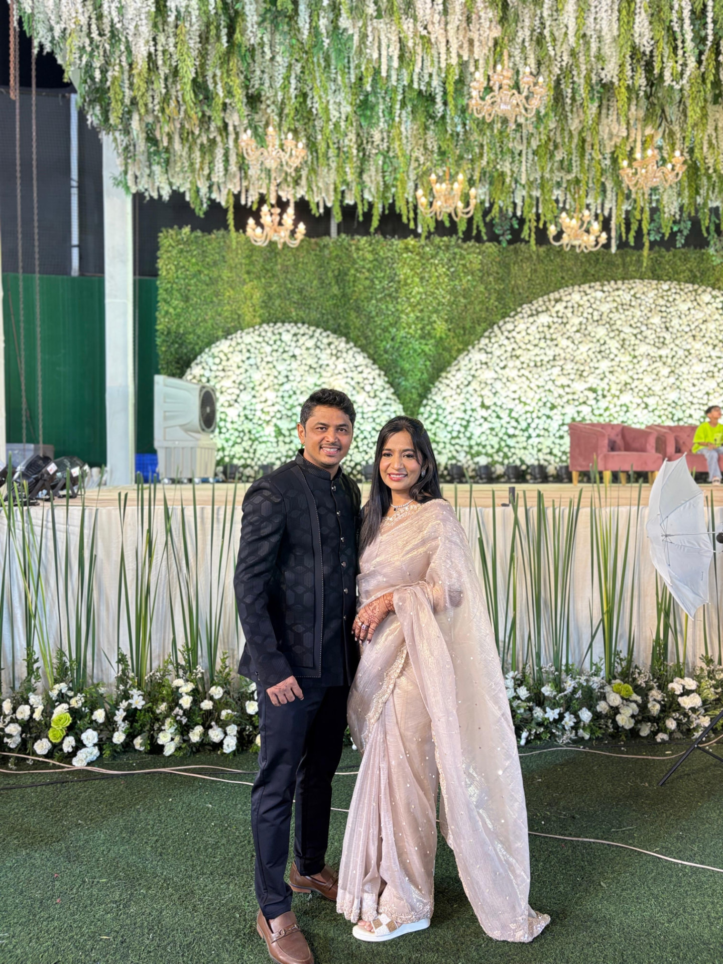 Together beneath flowers and chandeliers